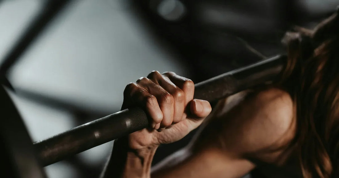 Hand gripping a loaded barbell